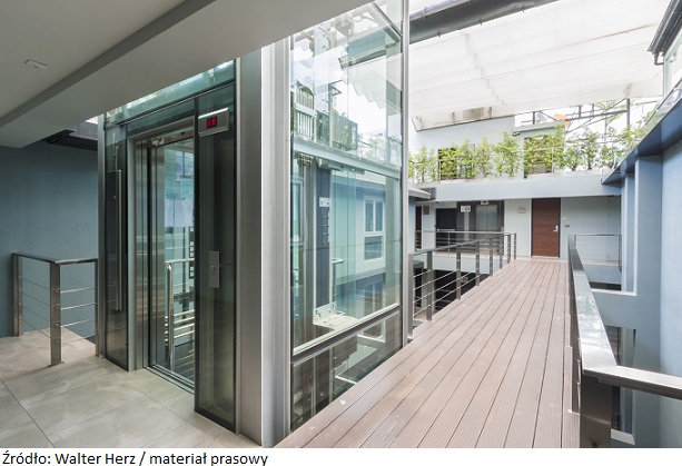 apartment interior with walkway bridge and glass lift opened.
